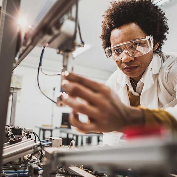 Black Female Engineer working on Industrial Machine