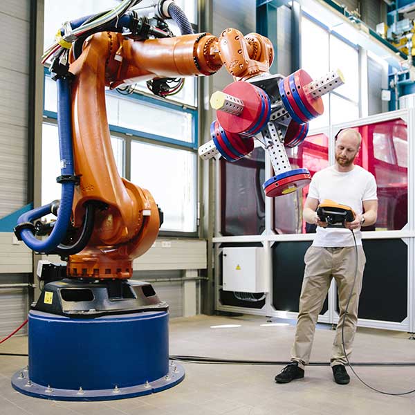 Young Engineer works at a Robotic Arm